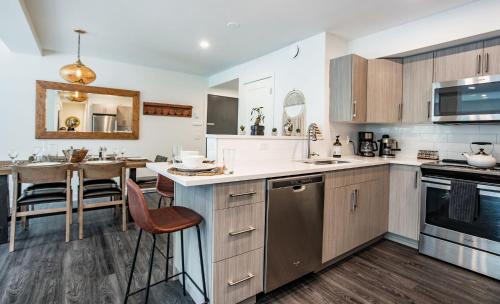 a kitchen with wooden cabinets and a dining room at L'Austin Rêve by Revelstoke Vacations in Revelstoke