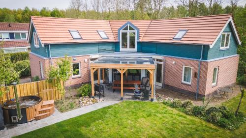 an overhead view of a house with an open patio at Newly renovated luxurious Villa / hottub / sauna / 7 bedrooms in Zeewolde