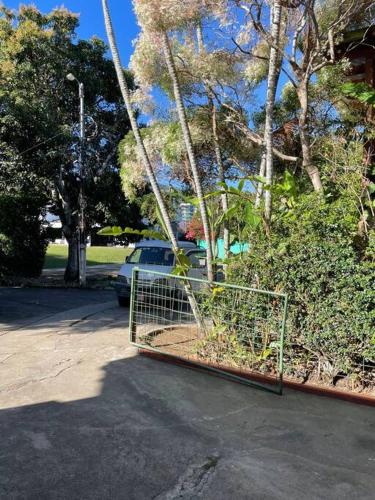 a swing in a parking lot with a car at Rainforest Cabin in Escazu in Escazu