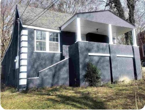 a small house with a garage with a door at Hilltop Hideaway in Atlanta