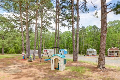 a playground with a swing and a playground at Tree-Lined Higden Retreat Close to Parks and Trails in Fairfield Bay