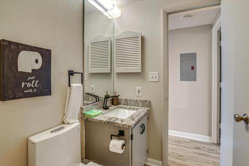 a bathroom with a sink and a mirror at Mod Myrtle Beach Resort Condo with Beach Access in Myrtle Beach