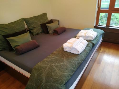 A bed or beds in a room at Aquincum Dunaparti Apartman