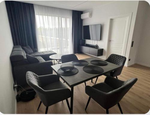 ein Wohnzimmer mit einem Tisch und Stühlen in der Unterkunft Nuomuojamas jaukus butas. in Klaipėda