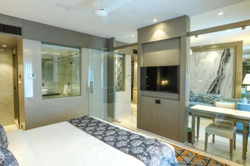 a bedroom with a bed and a television in a room at InstaFeel Hotel in Navi Mumbai