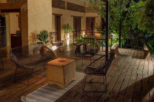 a patio with chairs and tables in a building at Casa Adobe Finca in La Peña
