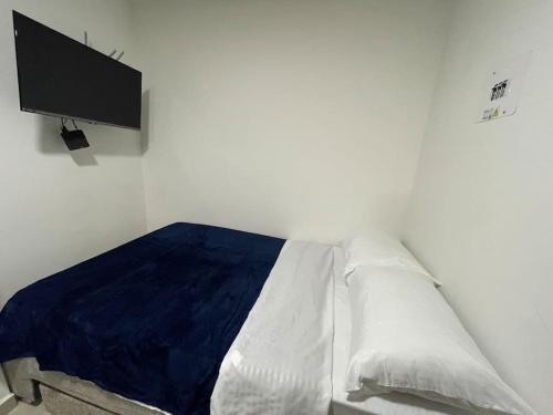 een slaapkamer met een bed en een tv aan de muur bij Apartaloft en el centro 204 in Pereira