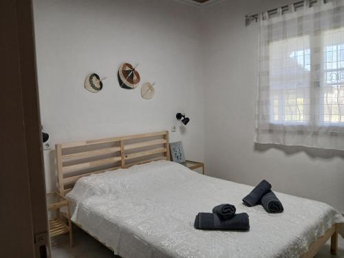 a bedroom with a bed with two towels on it at Kanela House in Nea Kalikratia