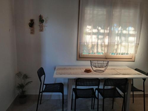 a table and chairs in a room with a window at Kanela House in Nea Kalikratia