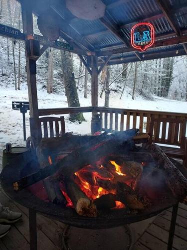 a fire in a grill in the snow at Mountain Cabin in woods 3 minutes to Helen #13 in Helen