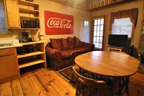 a living room with a couch and a table at Mountain Cabin in woods 3 minutes to Helen #13 in Helen