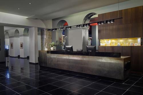 a lobby with a reception desk in a building at Hôtel de Bourgtheroulde, Autograph Collection in Rouen