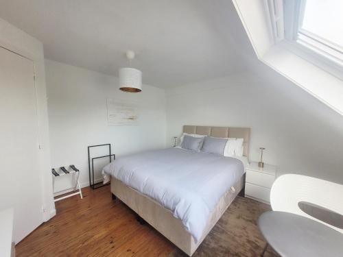 um quarto branco com uma cama branca e uma janela em Duplex Apartment em Varsenare