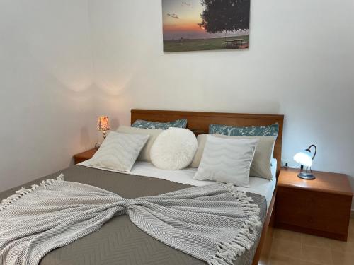a bedroom with a bed with a bow on it at Sweet Home Sofia in Norma