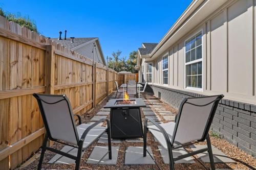 a patio with two chairs and a table and a fire pit at Easy E-0 3 MI Walk to DT & Momentary in Bentonville