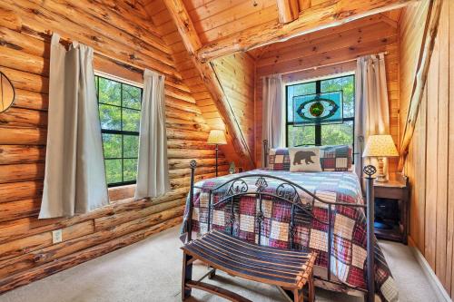 a bedroom with a bed in a log cabin at Heavenly View in Townsend