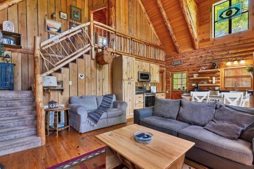 a living room with a couch and a table in a cabin at Heavenly View in Townsend