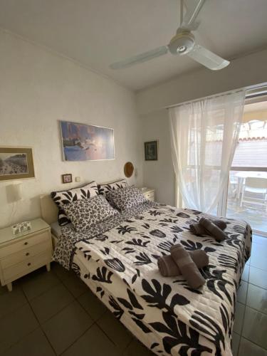 a bedroom with a black and white bed with a window at Villa V in Limne