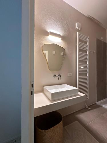 a bathroom with a white sink and a mirror at MAISON BENGASI in Civitanova Marche