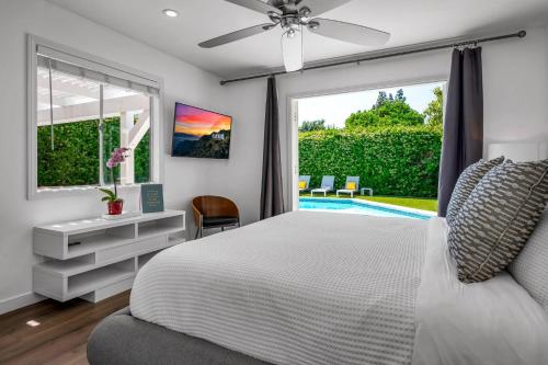 a bedroom with a white bed and a window at Sophia's Pool Oasis in Los Angeles