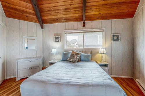 a bedroom with a large bed and a window at The Octagon on the Beach in Seaside