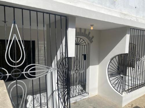 a black iron gate on a building with a door at María house in Santo Domingo