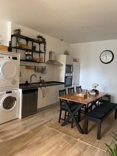 a kitchen and dining room with a table and appliances at Apartamento Donosti Aldea in Lasarte