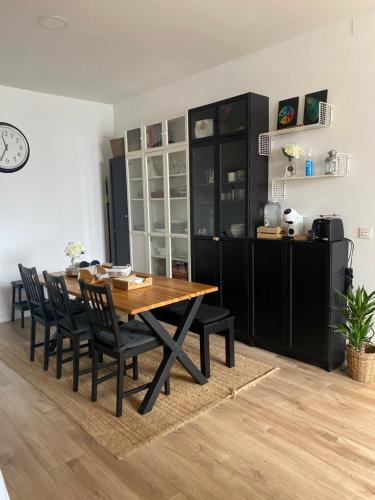 a dining room with a wooden table and chairs at Apartamento Donosti Aldea in Lasarte