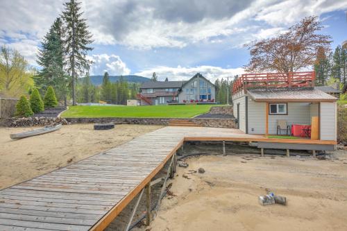 a home under construction with a wooden deck at Beachfront Sagle Retreat with Boat Dock and Lift in Sagle