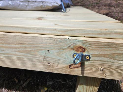 a pair of scissors on a piece of wood at Hidden Hollow Campsite at Hocking Vacations - Tent Not Included in Logan