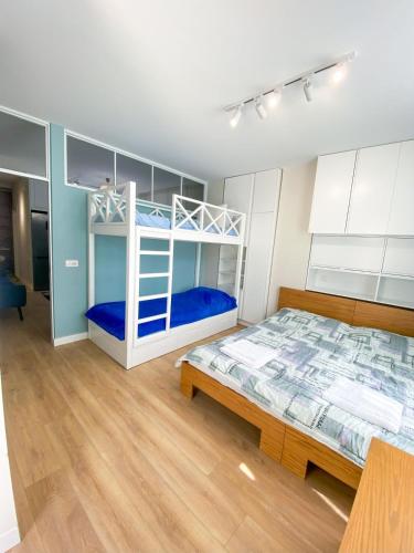 a bedroom with two bunk beds and a table at Albanian Dream Escape Apartment in Golem