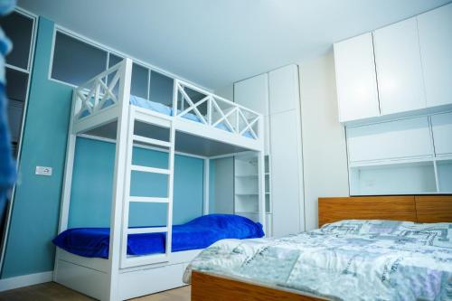 a bedroom with a bunk bed and blue walls at Albanian Dream Escape Apartment in Golem