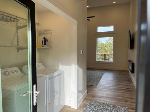 a laundry room with a washer and dryer and a window at Thunder Hollow in Ruidoso