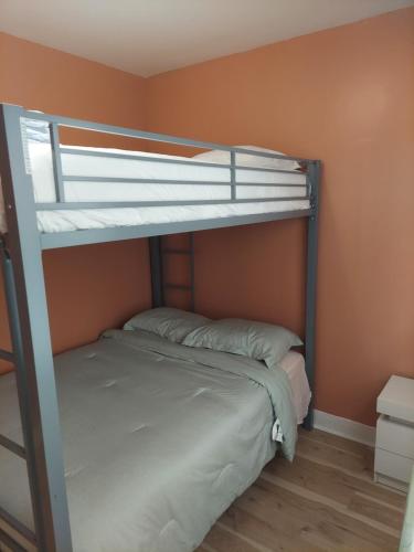 a bedroom with two bunk beds in a room at Queens chateau in Laurelton