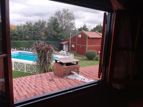 a view from a window of a patio with a pool at Complejo Cantonavi in Mina Clavero