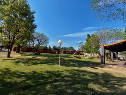 a park with a light pole in the grass at Complejo Solitudine in Cacheuta