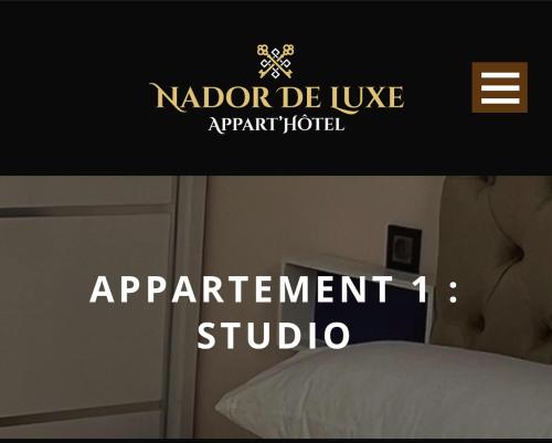 a sign for an apartment studio with a bed at Apart Nador de Luxe 1 in Nador