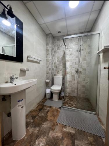 a bathroom with a shower and a toilet and a sink at Apart Nador de Luxe 1 in Nador