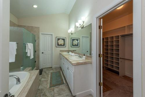 a bathroom with two sinks and a tub and a bath tub at Luxurious 4BR Retreat - Pool Table & Chic Amenities in Boulder