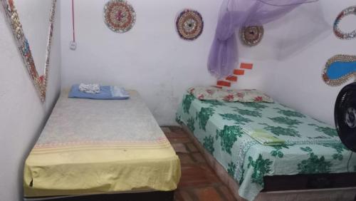 a bedroom with two beds in a room at POUSADA ATINS MELo in Atins