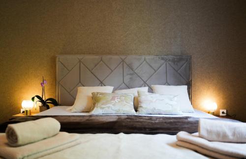 a bedroom with a large bed with white sheets and pillows at Luxury apartment Vasilisa in Kotor