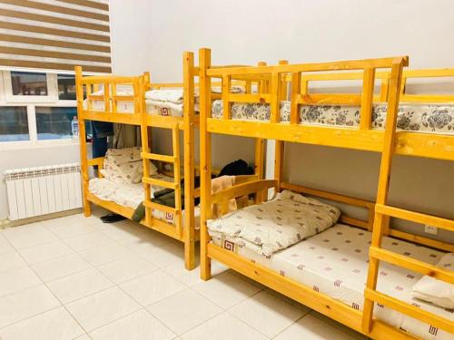 a group of bunk beds in a room at Sakhohostel in Karategin