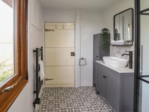 a bathroom with a sink and a mirror at Pengeulan in Machynlleth