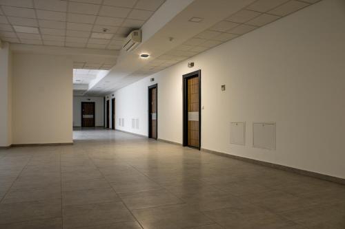 an empty hallway with white walls and brown doors at Lalas' apartment in Ohrid