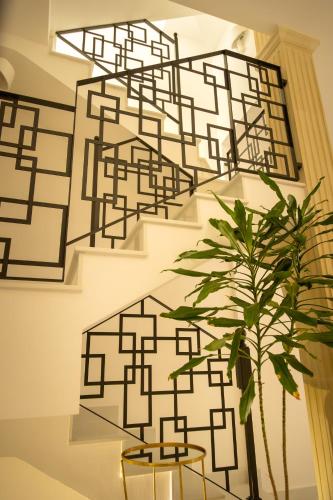 a staircase with a plant in front of a wall at La Terrazza Nel Borgo B&B in Copertino