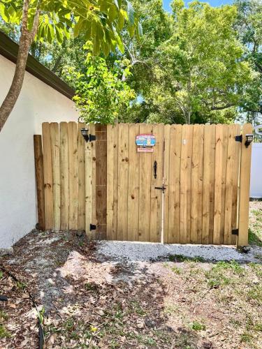 a wooden fence with a gate in a yard at Garden Paradise RV Camper near Clearwater Beaches in Largo