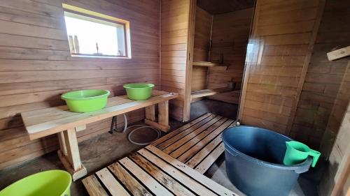 a bathroom with a tub and two bowls on a table at Plagandõ puhkemaja 