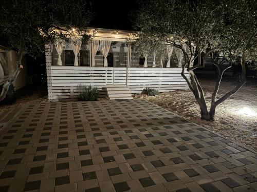 a house at night with a brick driveway at Marty House Drage in Drage