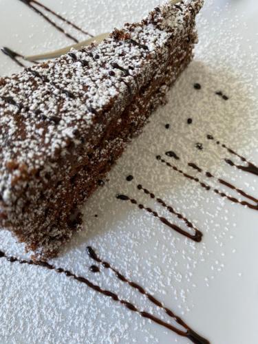 a piece of chocolate cake on a white plate at Hotel Sinuessa Terme in Mondragone