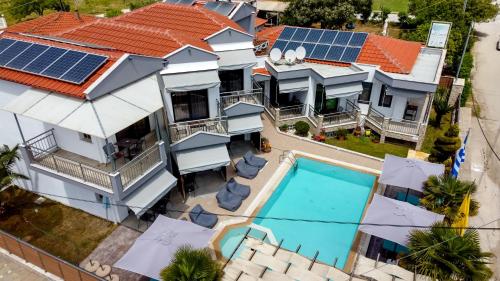 an aerial view of a house with solar panels on the roof at Sea Pearl Luxury Apartments in Nea Vrasna